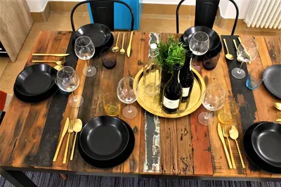 a wooden table with wine glasses and wine bottles at Exclusive Central Apartment 48 in Rome