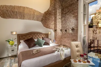 a bedroom with a bed and a brick wall at Guesthouse MySuiteTower Pantheon in Rome
