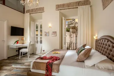 a bedroom with a bed and a desk in a room at Guesthouse MySuiteTower Pantheon in Rome
