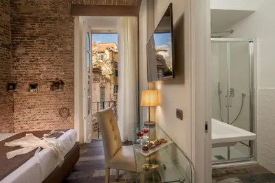 a hotel room with a bed and a glass table at Guesthouse MySuiteTower Pantheon in Rome