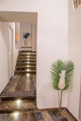 a plant in the middle of a hallway with stairs at Guesthouse MySuiteTower Pantheon in Rome