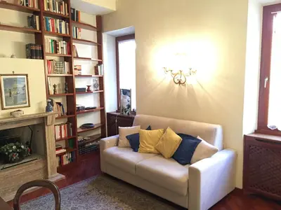 a living room with a couch and a book shelf at A CASA DI ZIA LOLA in Rome