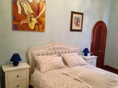 a bedroom with a bed and a painting on the wall at A CASA DI ZIA LOLA in Rome