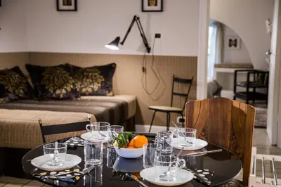 a dining room with a table with glasses on it at Vatican Jewel Apartment in Rome