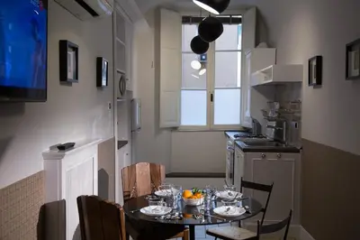 a small kitchen with a table with glasses on it at Vatican Jewel Apartment in Rome