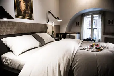 a bedroom with a large white bed in a room at Vatican Jewel Apartment in Rome