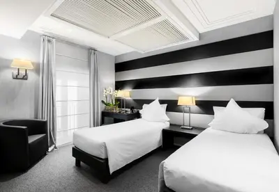 two beds in a hotel room with black and white stripes at Hotel Mancino 12 in Rome