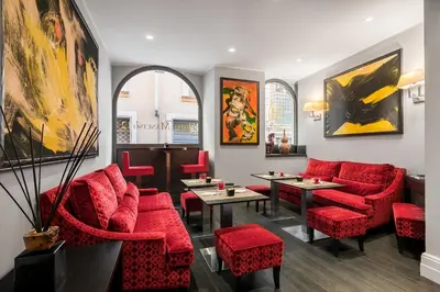 a restaurant with red chairs and tables and paintings at Hotel Mancino 12 in Rome
