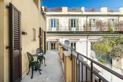 a balcony with two chairs and a table on it at Hotel Mancino 12 in Rome