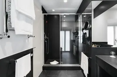 a black and white bathroom with a shower at Hotel Mancino 12 in Rome