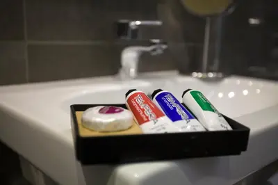 a bathroom sink with toothbrushes and toothpaste at Colosseo Prestige Rooms in Rome