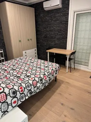 a bedroom with a bed and a desk and a table at Alloggio Roma Appia in Rome