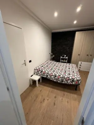 a bedroom with a bed in a white room at Alloggio Roma Appia in Rome
