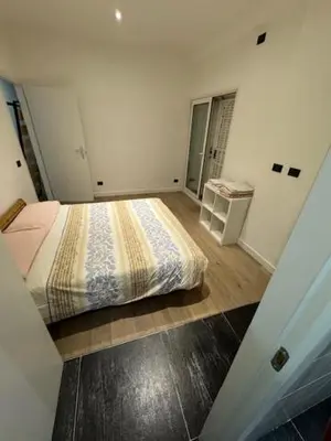a small bedroom with a bed and a table at Alloggio Roma Appia in Rome