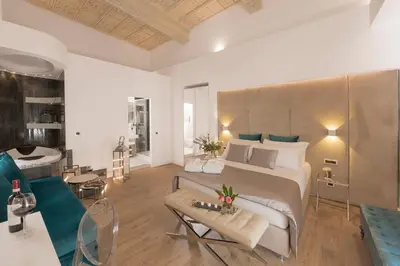 a bedroom with a large bed and a living room at Navona Style in Rome