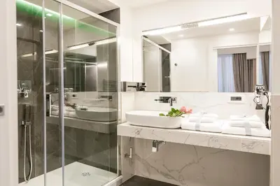 a bathroom with a sink and a glass shower at Navona Style in Rome