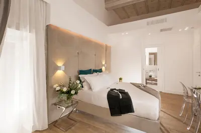 a bedroom with a large bed and a table with flowers at Navona Style in Rome