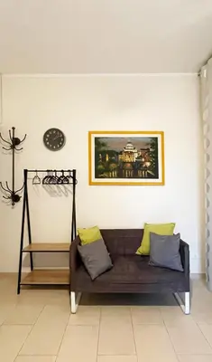 a couch in a living room with a picture on the wall at Studio Flat Vaticano in Rome