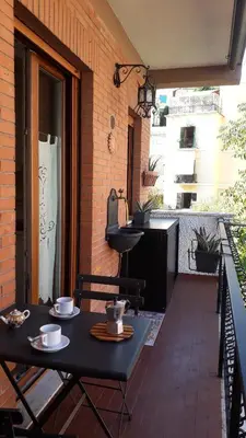 a black table and chairs on an outdoor patio at Studio Flat Vaticano in Rome
