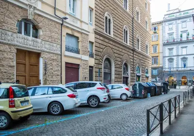 a row of cars parked on a street next to buildings at Ara Pacis Inn in Rome