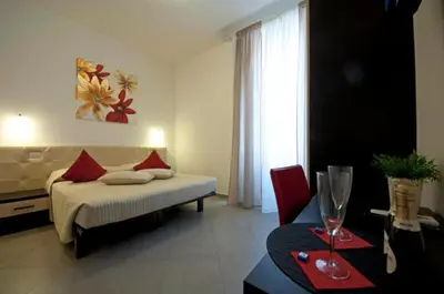 a hotel room with a bed and a table with a table sidx sidx at Ara Pacis Inn in Rome