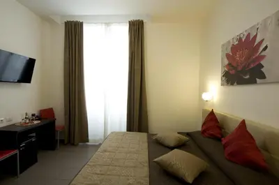 a hotel room with a bed and a window at Ara Pacis Inn in Rome