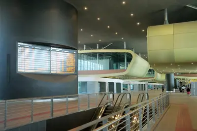 a hallway in a building with escalators and a building at B&B Dea Tiburtina in Rome