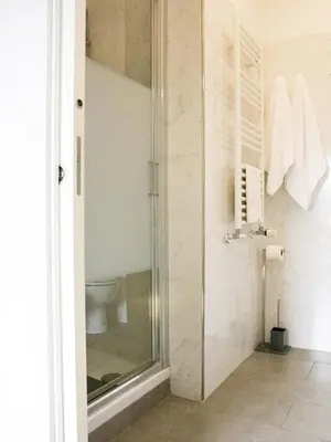 a bathroom with a shower and a toilet at B&B Dea Tiburtina in Rome