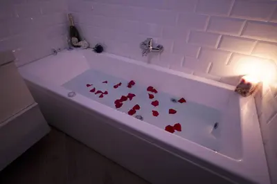 a white bath tub with red hearts on it at Affittacamere Arte nei Colori in Rome
