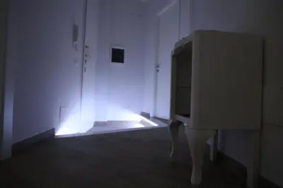 a tv in a white room with lights on it at Affittacamere Arte nei Colori in Rome