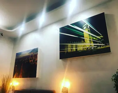 a living room with a tv hanging on the wall at CityLife Rome in Rome