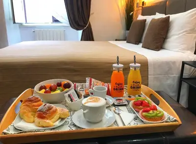 a tray of breakfast food on a table in a hotel room at CityLife Rome in Rome