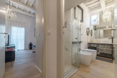 a bathroom with a glass shower and a sink at GuestHost - Piazza Venezia&Colosseum Loft in Rome