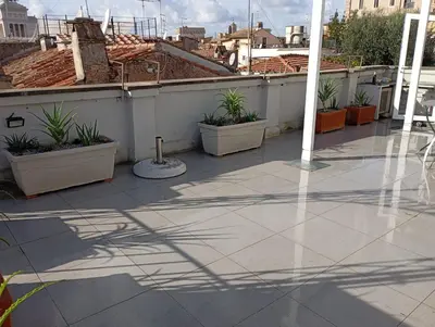 a patio with potted plants on a roof at GuestHost - Piazza Venezia&Colosseum Loft in Rome