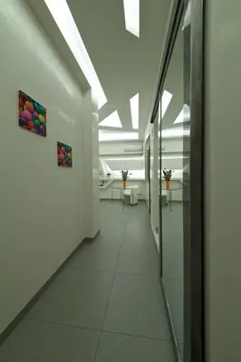 a corridor in a building with white walls and ceilings at Roma Naif Rooms in Rome