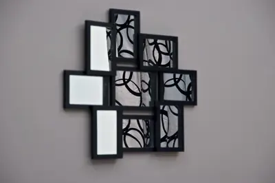 a black cross hanging on a wall at Roma Naif Rooms in Rome