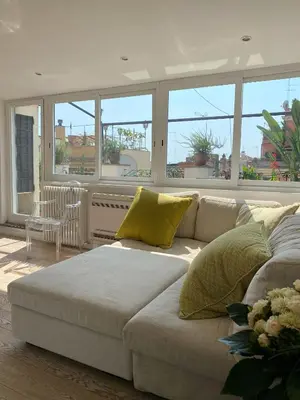 a white couch in a living room with windows at Art Lover's Loft in Rome