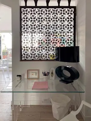 a glass table in a room with a picture on the wall at Art Lover's Loft in Rome
