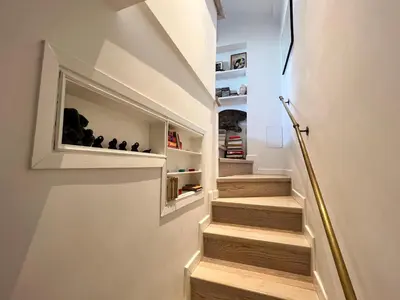 a staircase in a house with a built in book shelf at Art Lover's Loft in Rome