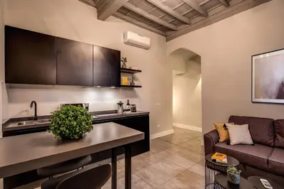 a kitchen and a living room with a couch at 11 Via di Sant'Eligio in Rome