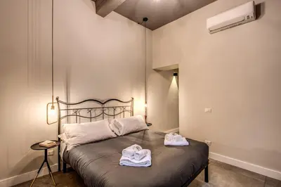 a bedroom with a bed with towels on it at 11 Via di Sant'Eligio in Rome