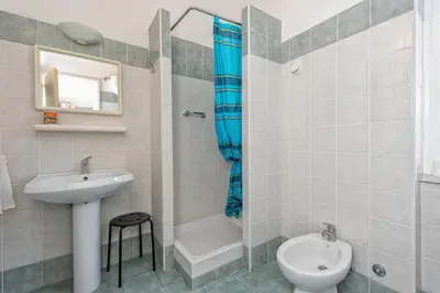 a bathroom with a sink and a toilet and a shower at A Vinicius et Mita in Rome