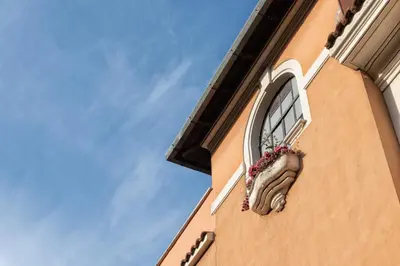 a building with a window with a flower pot on it at A Vinicius et Mita in Rome