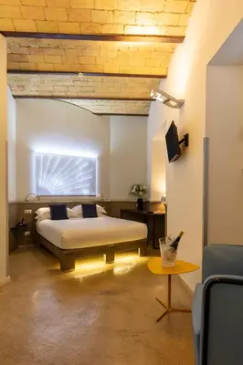 a living room with white walls and a wooden ceiling at Hotel La Rovere in Rome