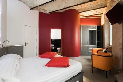 a bedroom with a bed and a chair in a room at Hotel La Rovere in Rome