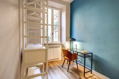 a room with a desk and a chair and a window at Sant'Eligio 2BDR in Rome