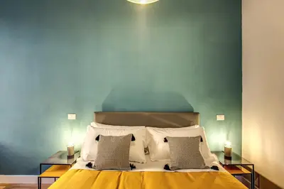 a bedroom with a large bed with two lamps at Sant'Eligio 2BDR in Rome