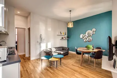 a kitchen and living room with a table and a couch at Sant'Eligio 2BDR in Rome