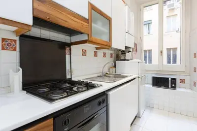 a kitchen with a stove and a sink at Casa Vacanze Risorgimento in Rome