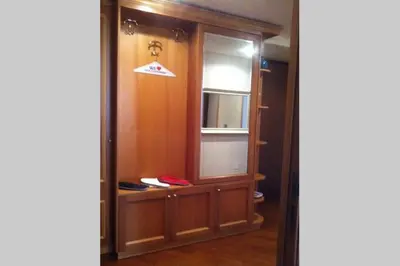 a room with a window and a cabinet with a mirror at Casa Vacanze Risorgimento in Rome